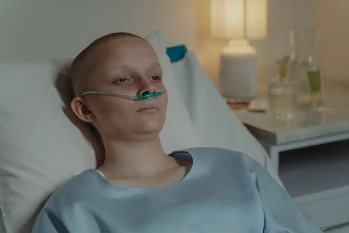 A hospital radiation therapy room with equipment at rest, clean and clinical, representing modern cancer treatment technology