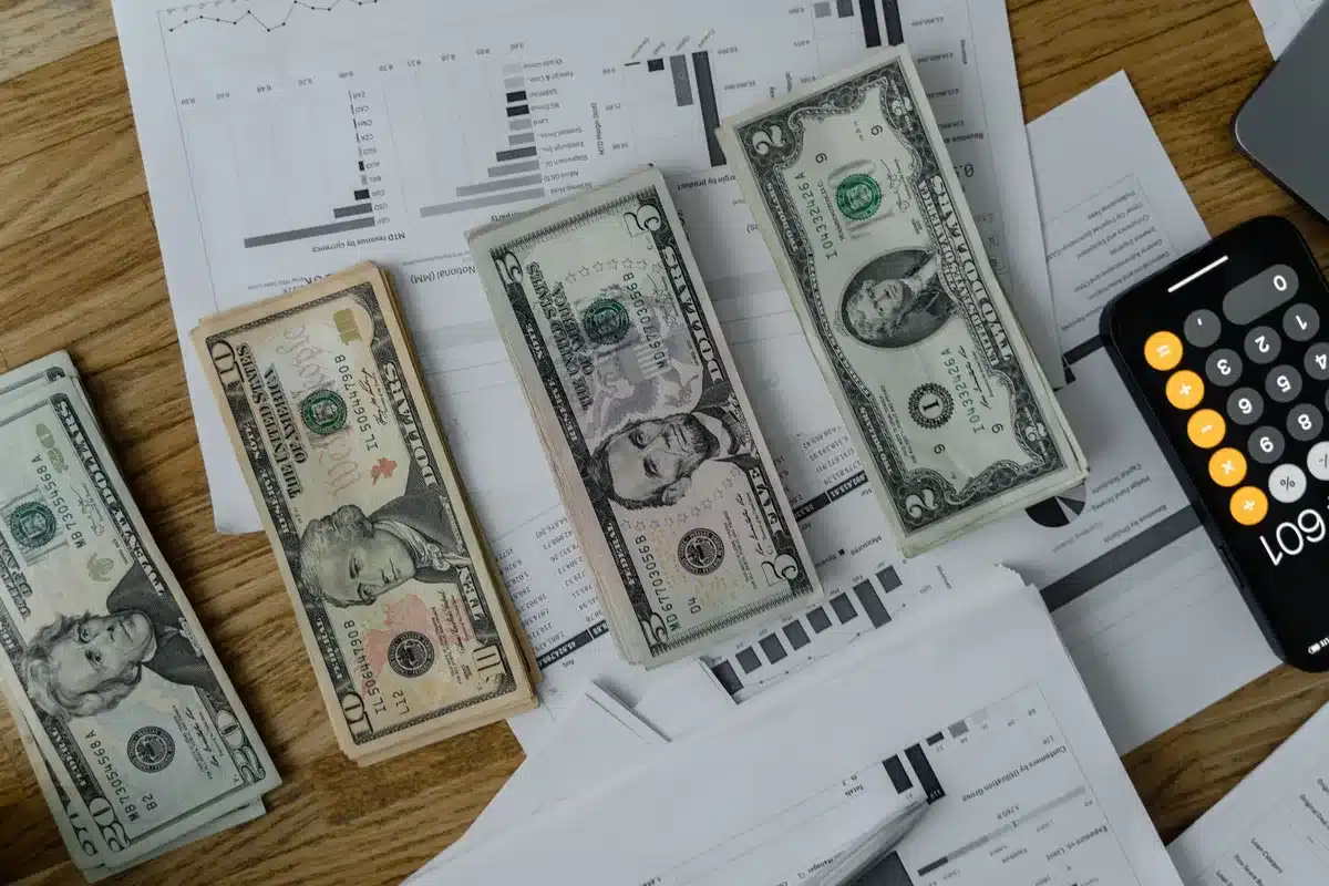 A corporate earnings report document with highlighted financial figures and upward-pointing arrow graphics on a desk