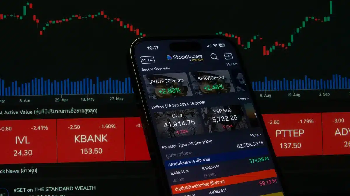 Bond trader monitoring multiple screens showing rising yield curves and market data