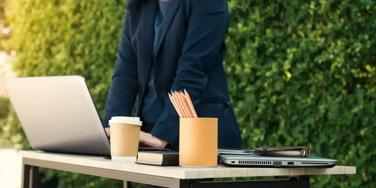 A tech executive's desk with multiple monitors displaying productivity dashboards and AI interfaces, minimalist office setting, focused intensity