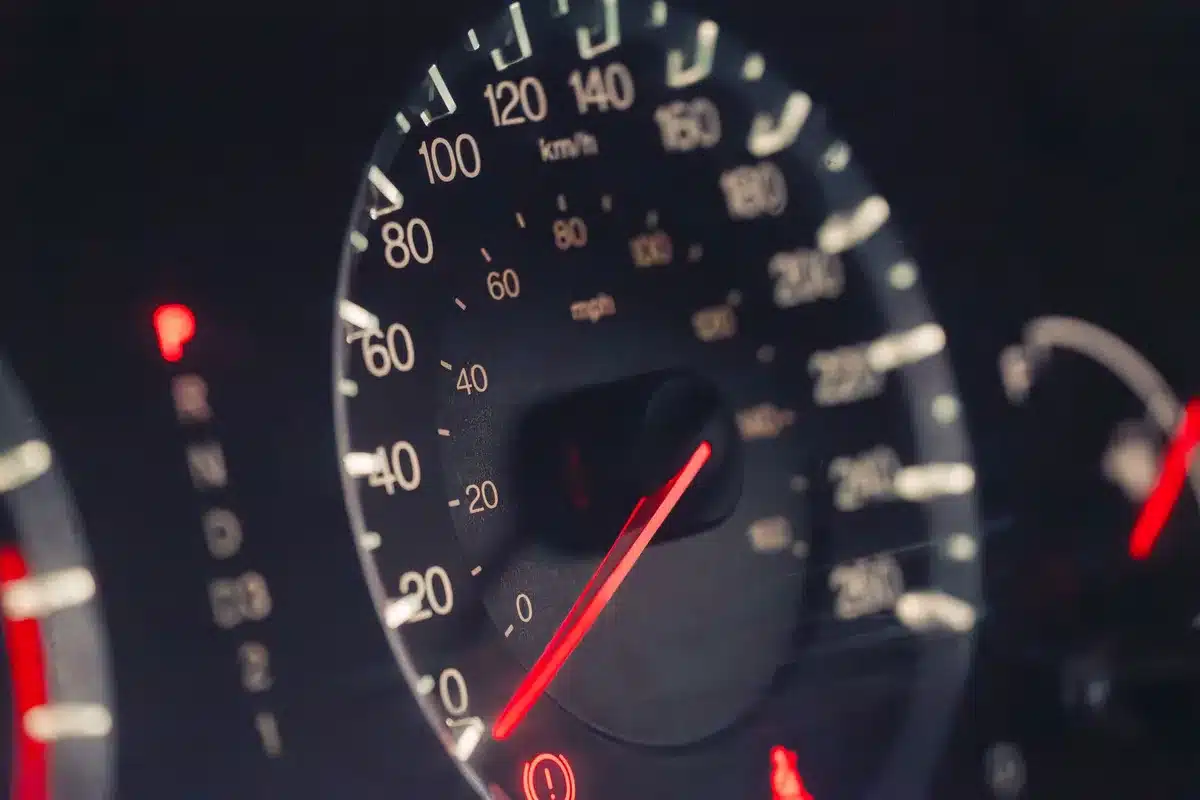 A dark car dashboard with a blank digital instrument cluster display showing no speed, fuel gauge, or warning lights visible.