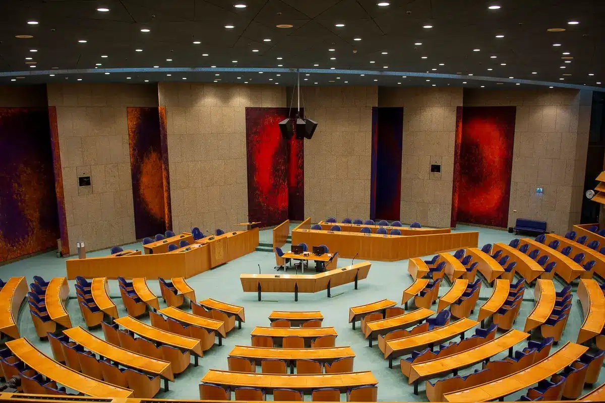 A dimly lit television studio with split podiums