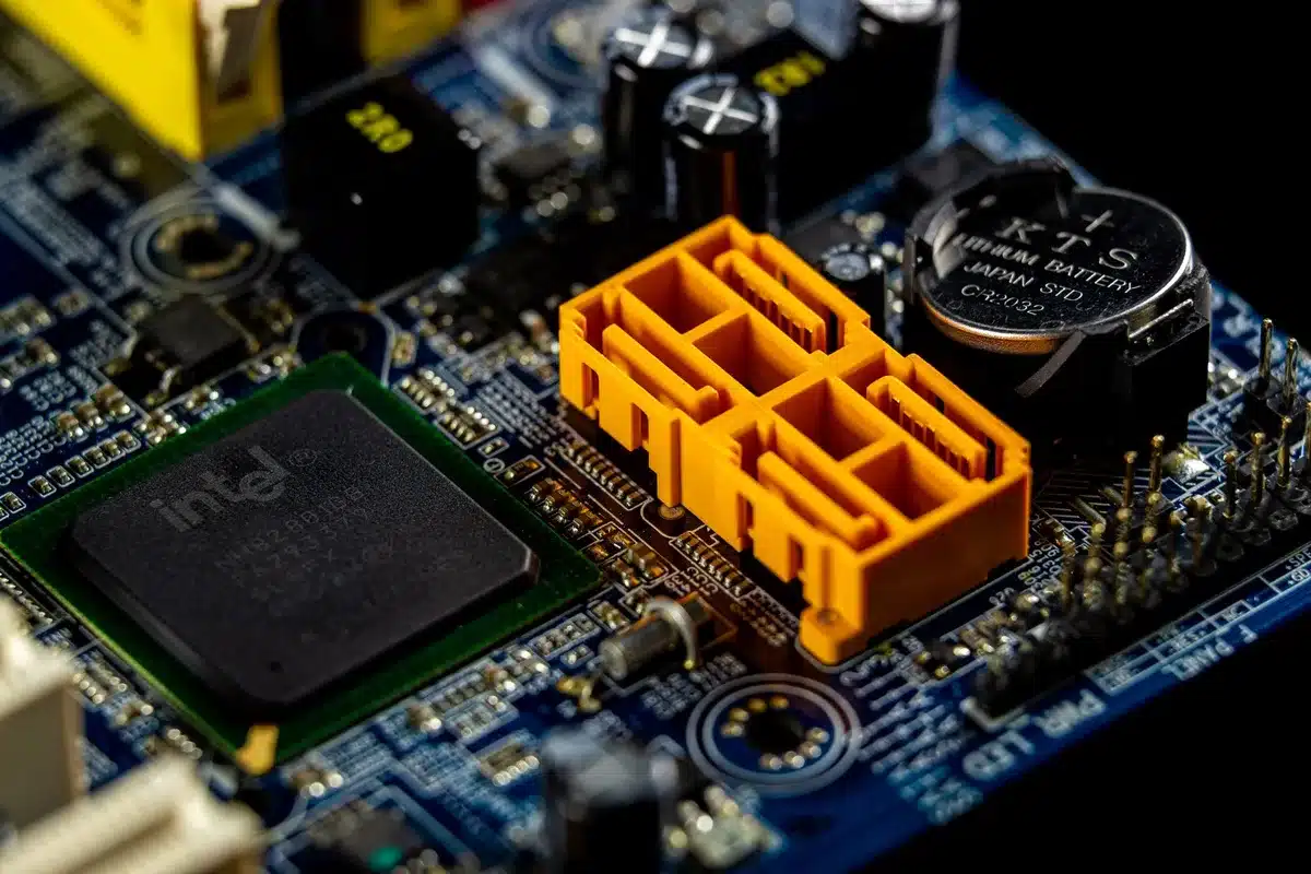 Semiconductor manufacturing facility with glowing circuit boards and data center server racks, blue and white lighting, showcasing advanced AI chip infrastructure