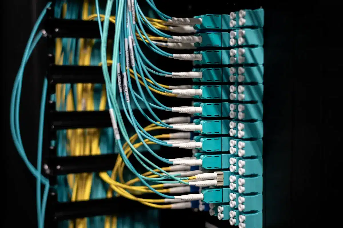 Data center server racks with glowing lights and network cables