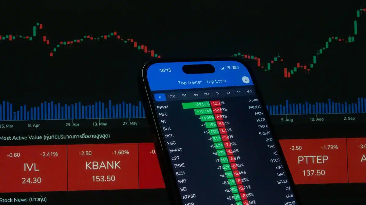 Stock market trading screen showing technology ticker symbols and green upward arrows
