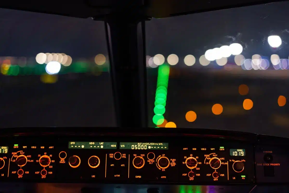 A professional dashboard displaying real-time cybersecurity metrics and threat analytics on a glowing screen, with layered data visualizations and charts reflecting green and blue tones, suggesting security monitoring and operational control.