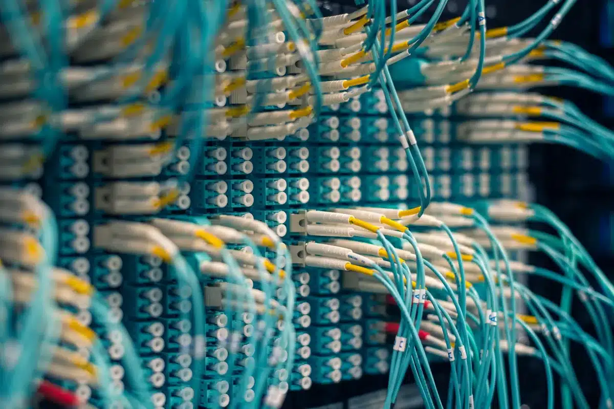 Abstract visualization of interconnected nodes and data flow, representing cloud infrastructure and AI partnerships, warm orange and cool blue tones merging, lines of light suggesting network connectivity and data movement
