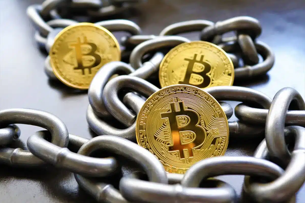Cryptocurrency symbols and blockchain code flowing across a dark screen, regulatory documents and compliance checkmarks overlaid, soft green glow indicating approval