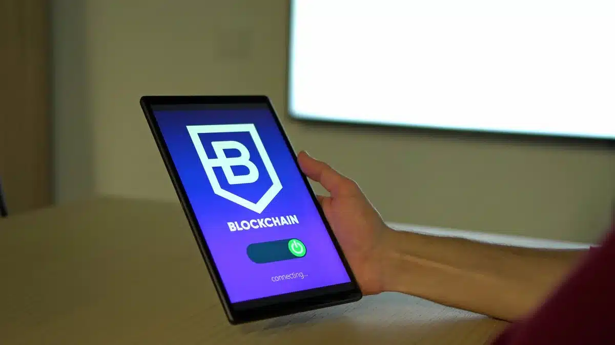 An emergency notification banner displayed on a computer monitor, warning cryptocurrency users about wallet security risks and the need to migrate funds to new wallets.
