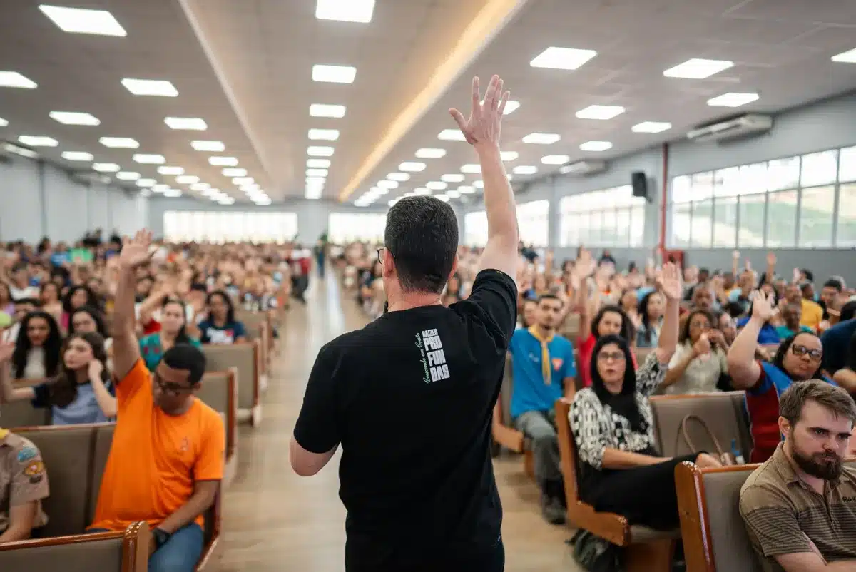 A crowded town hall meeting with residents raising hands and speaking from microphones, intense discussion and concern visible on faces, fluorescent lighting casting shadows, palpable tension and civic engagement