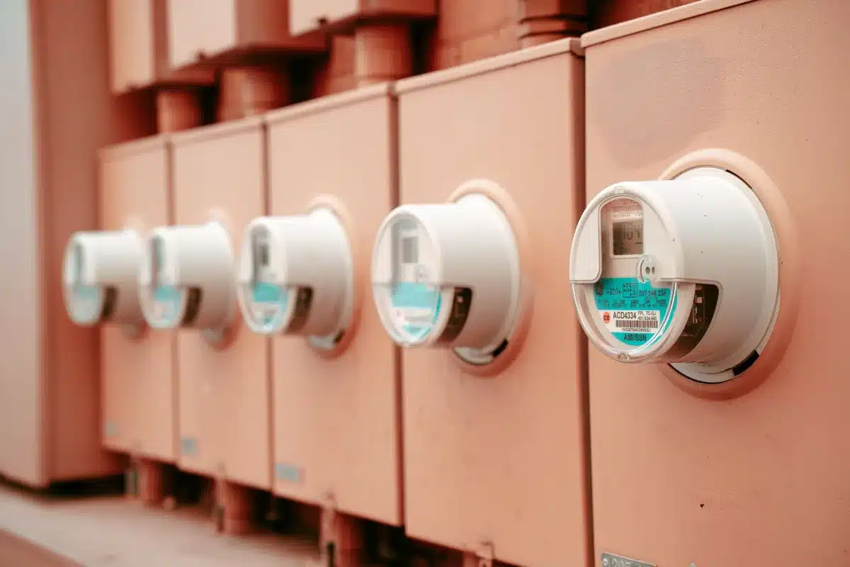 A utility substation with transformers and high-voltage switchgear against a grid background, illustrating the power infrastructure bottleneck limiting data center expansion