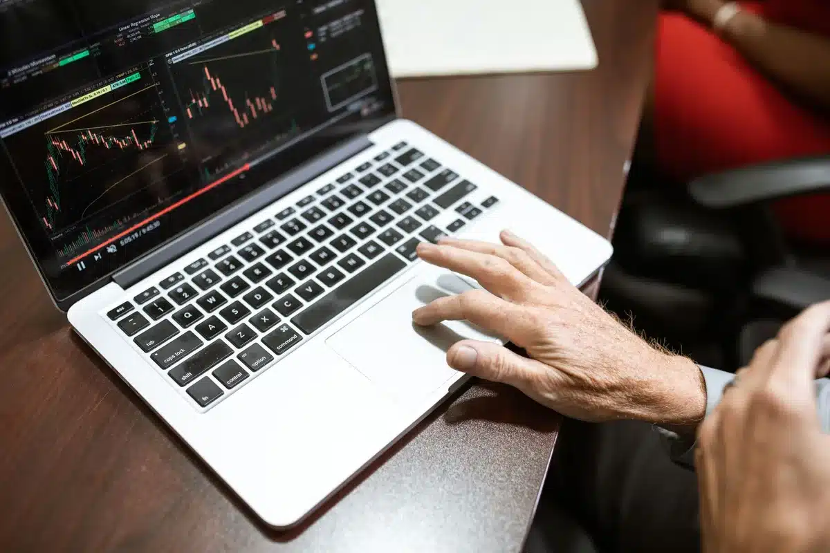 A financial advisor's desk with charts, graphs, and growth projections displayed on a computer screen, symbolizing professional guidance for wealth management.