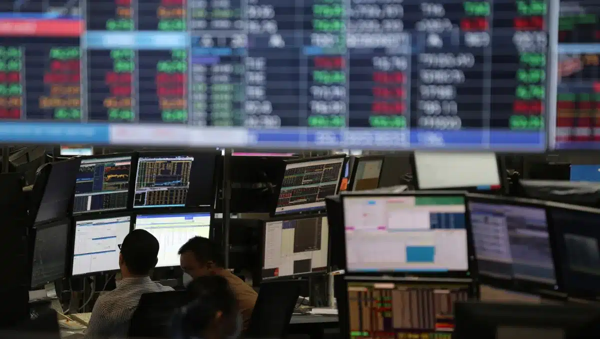 Stock market display with dividend yield percentages and financial data on screens | dividend stocks performance chart