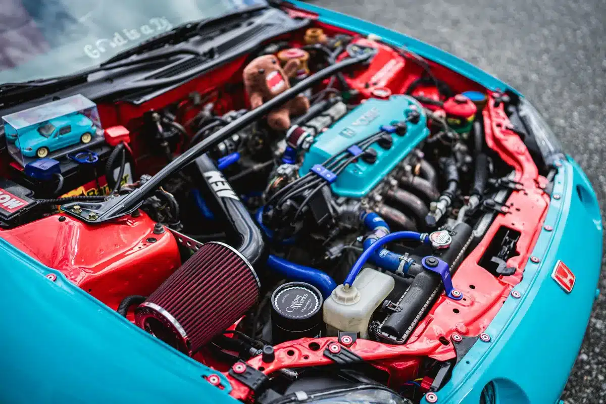 A high-powered turbocharged inline-six engine bay with visible turbochargers and intercoolers, technical detail shot showing the engineering complexity of the 600-hp setup