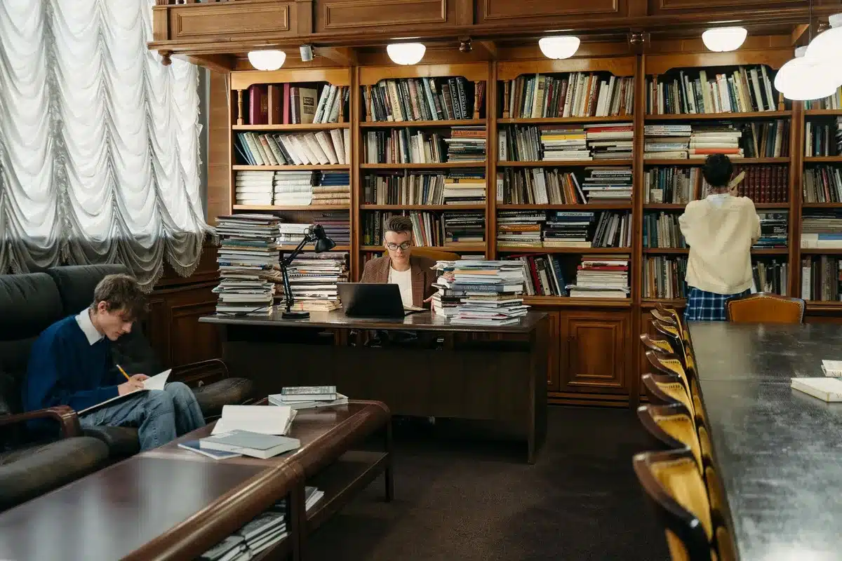 A law library with stacks of legal volumes and case files, desk with a coffee cup and reading glasses, soft lighting suggesting research and deliberation