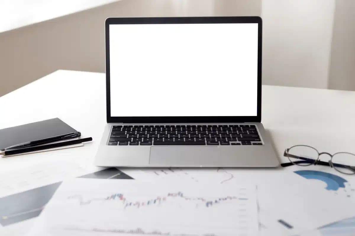 An empty currency trading desk with multiple screens displaying real-time market data, a coffee cup, and scattered financial documents, bathed in the glow of overnight trading activity.