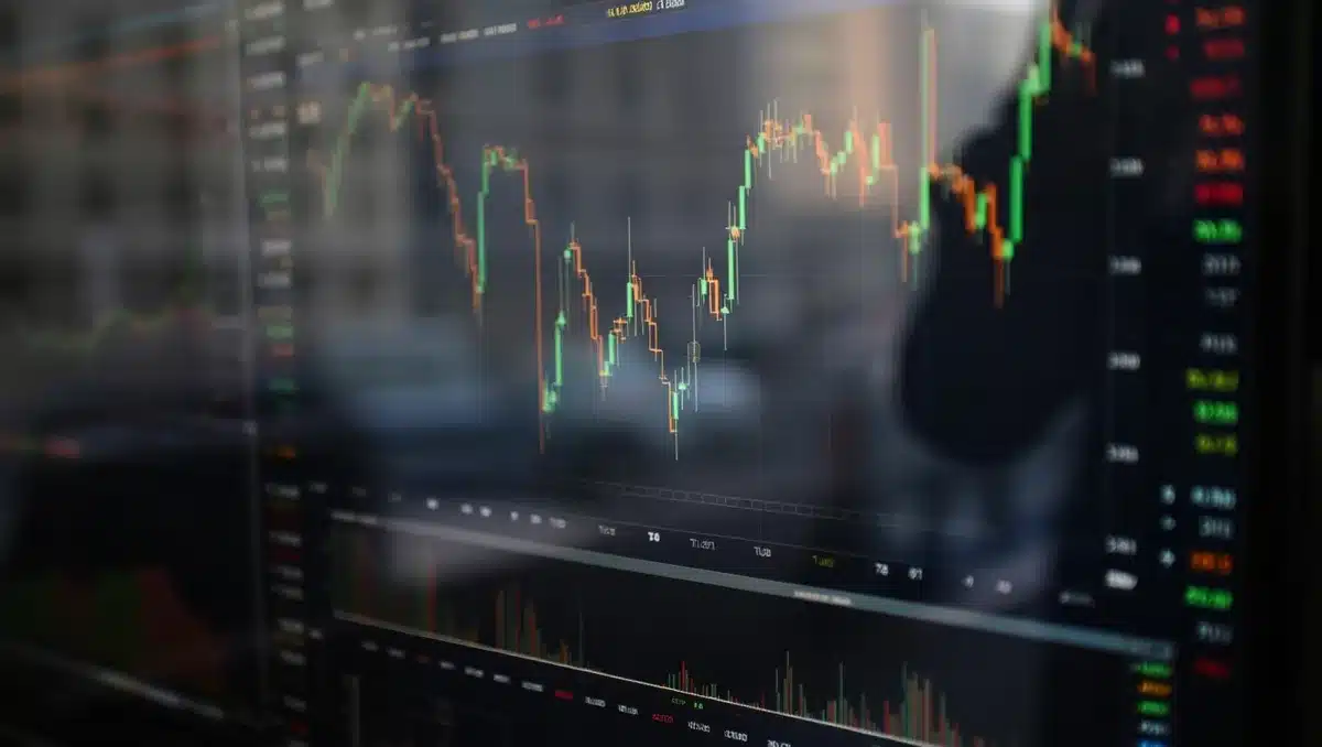 A stock market trading screen displaying climbing index values in bright green, candlestick charts moving upward, real-time ticker symbols scrolling across a dark background, with soft focus city skyline reflected in the glass — momentum.