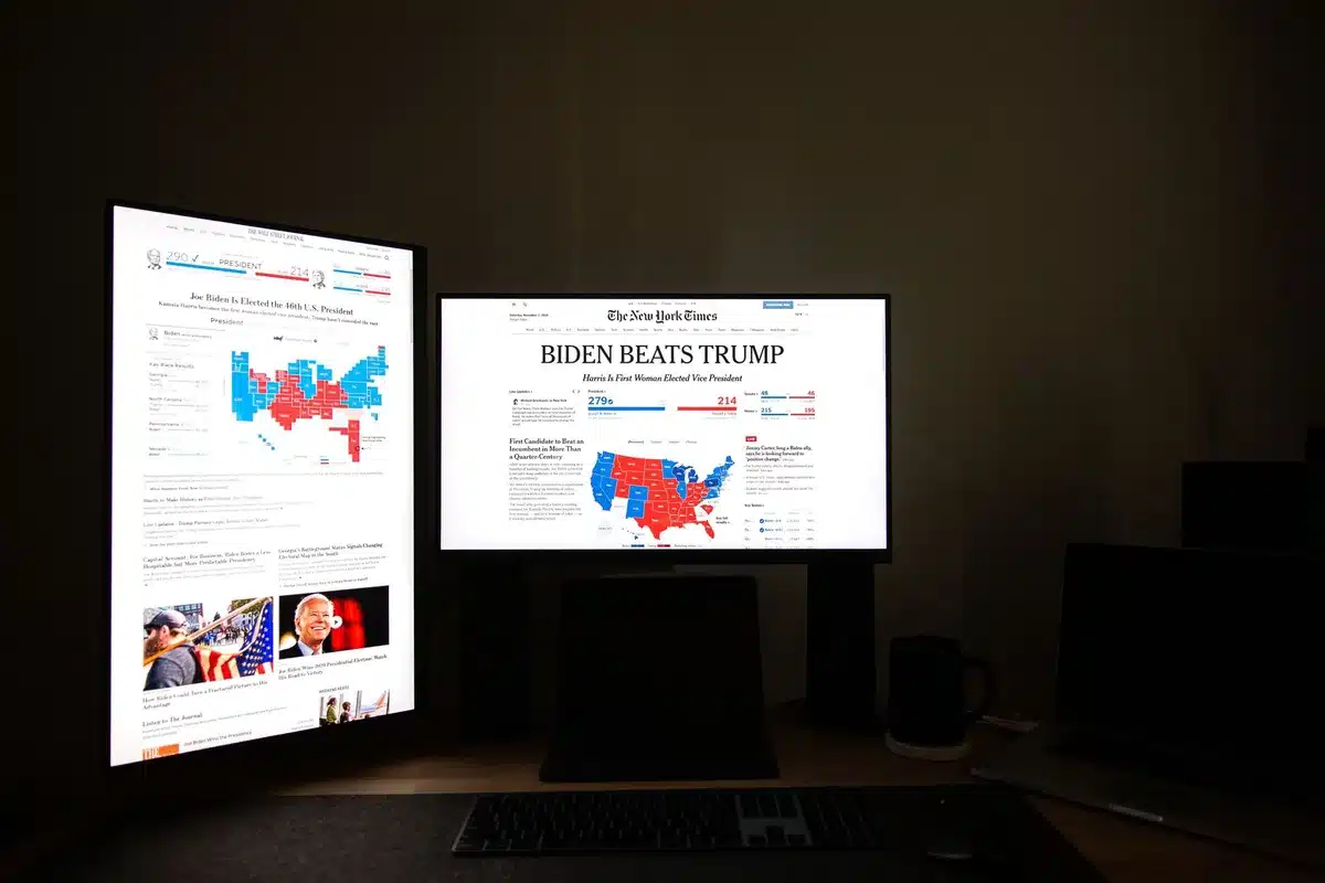 A split-screen showing two empty campaign headquarters&mdash;one with celebratory balloons and confetti partially deflated, the other with chairs turned backward and dimmed lights&mdash;contrasting victory and defeat in stark detail