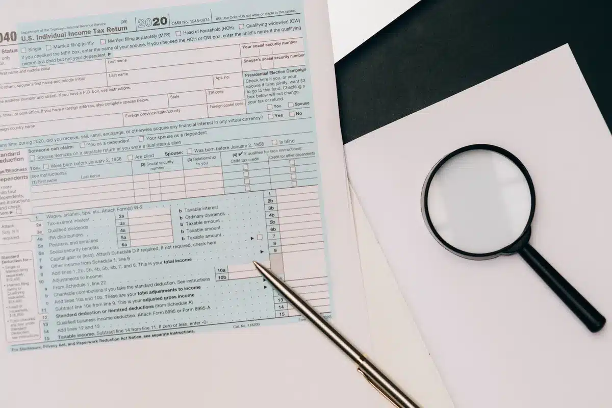 A close-up of financial documents and bonds spread across a desk with a calculator and pen, soft office lighting, shallow depth of field focusing on the bond certificates