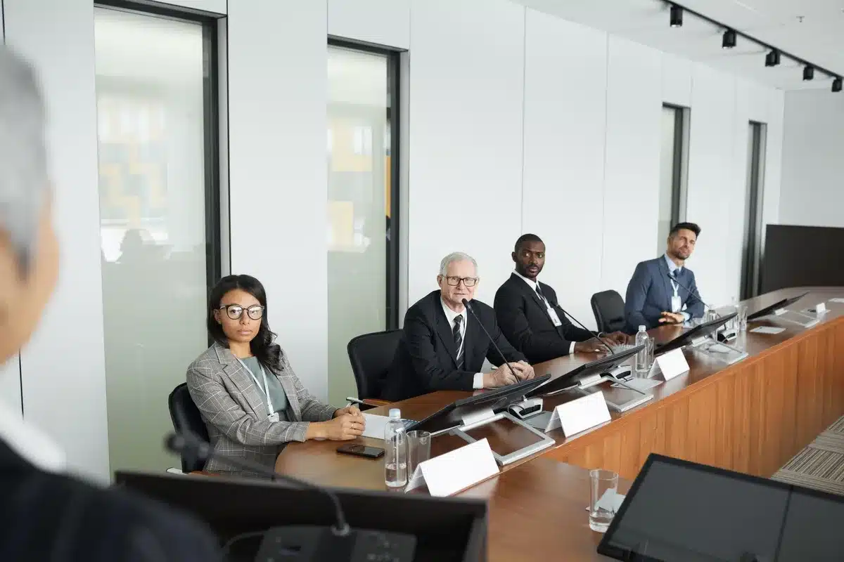 A sleek modern conference room with a large digital display showing the EA Games logo, empty chairs around a polished table, soft blue and white lighting suggesting a corporate boardroom