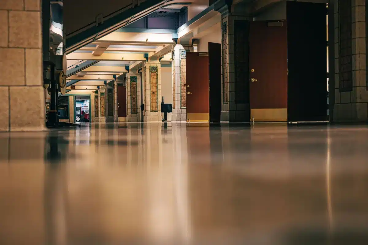 A courthouse hallway with empty benches and formal legal setting, natural light from windows, solemn and official atmosphere, no people