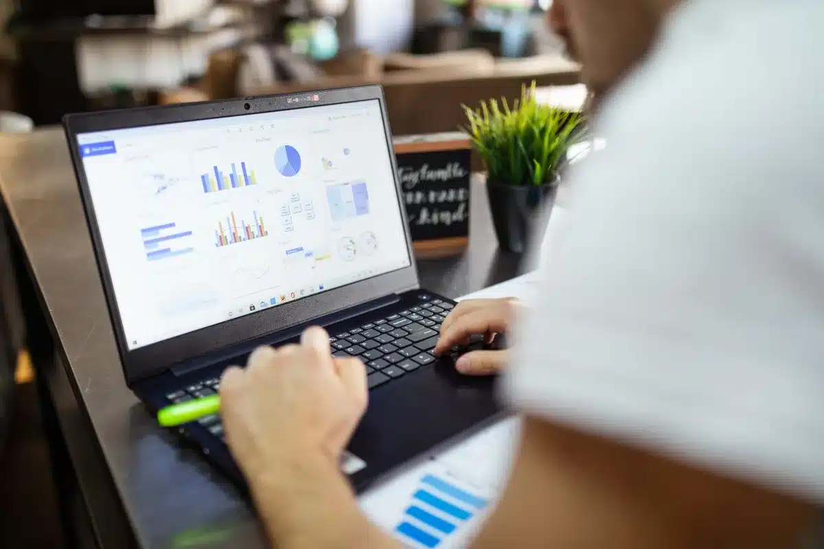 A financial dashboard or earnings report displayed on a monitor screen showing upward trending charts and profit metrics in green, representing guidance raises and earnings beats.