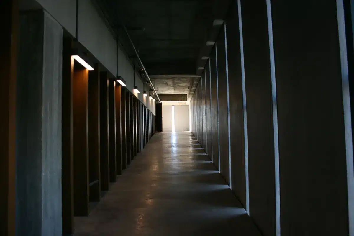 A courthouse hallway with wooden benches and soft natural light, documents visible on a table, conveying the formal weight of family court proceedings