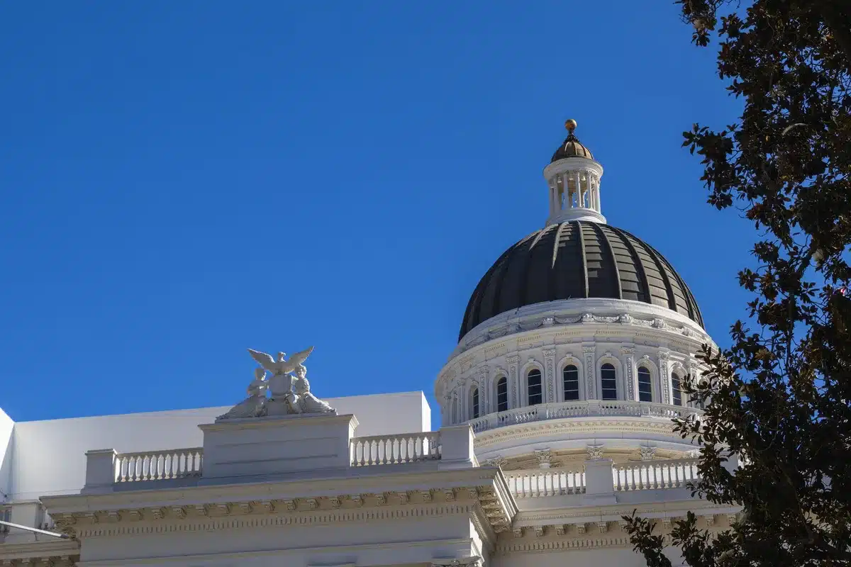 A Georgia state capitol building exterior at dusk with soft lighting, American flag visible, symbolizing state governance