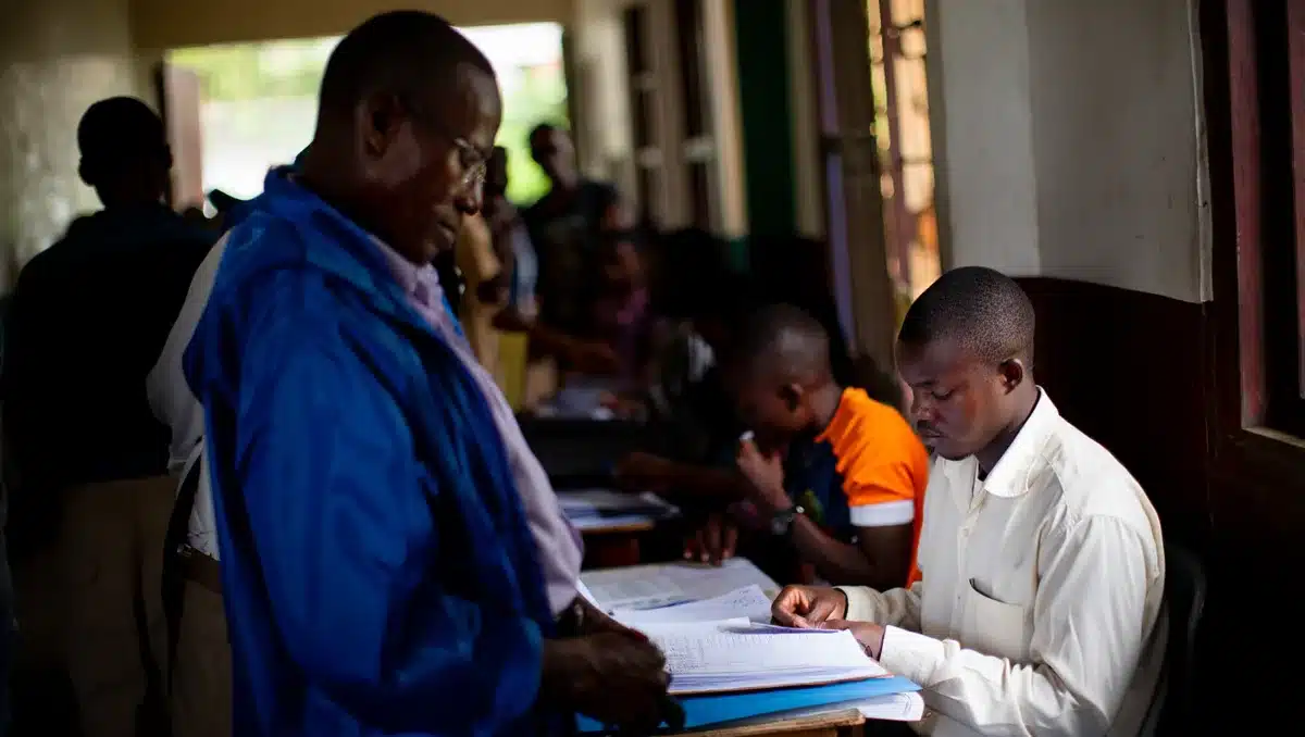A polling station with voters waiting in line, election workers checking registrations | primary election voting line