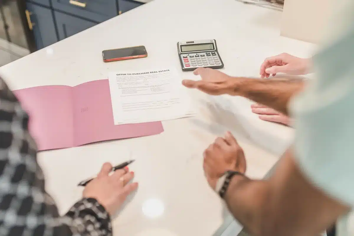 Mortgage paperwork and calculator on desk