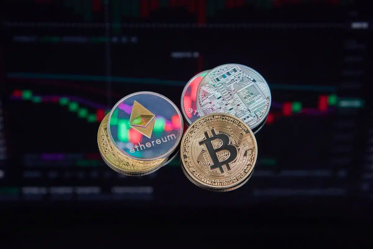 A modern trading terminal displaying stock tickers and blockchain network visualization, with digital asset icons representing tokenized equities floating across the screen.