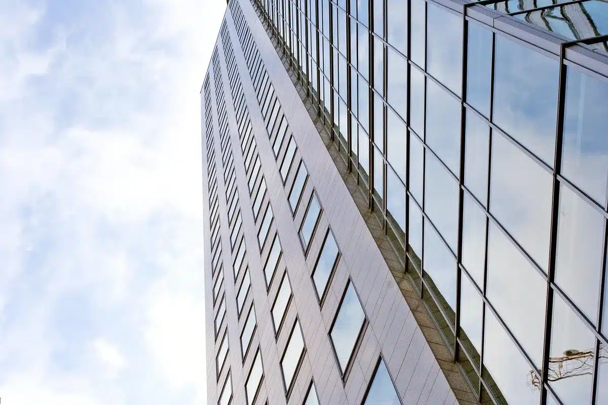 A corporate office building with "Humana" signage, morning light streaming through glass facades, representing insurance industry headquarters and strategic business decisions.