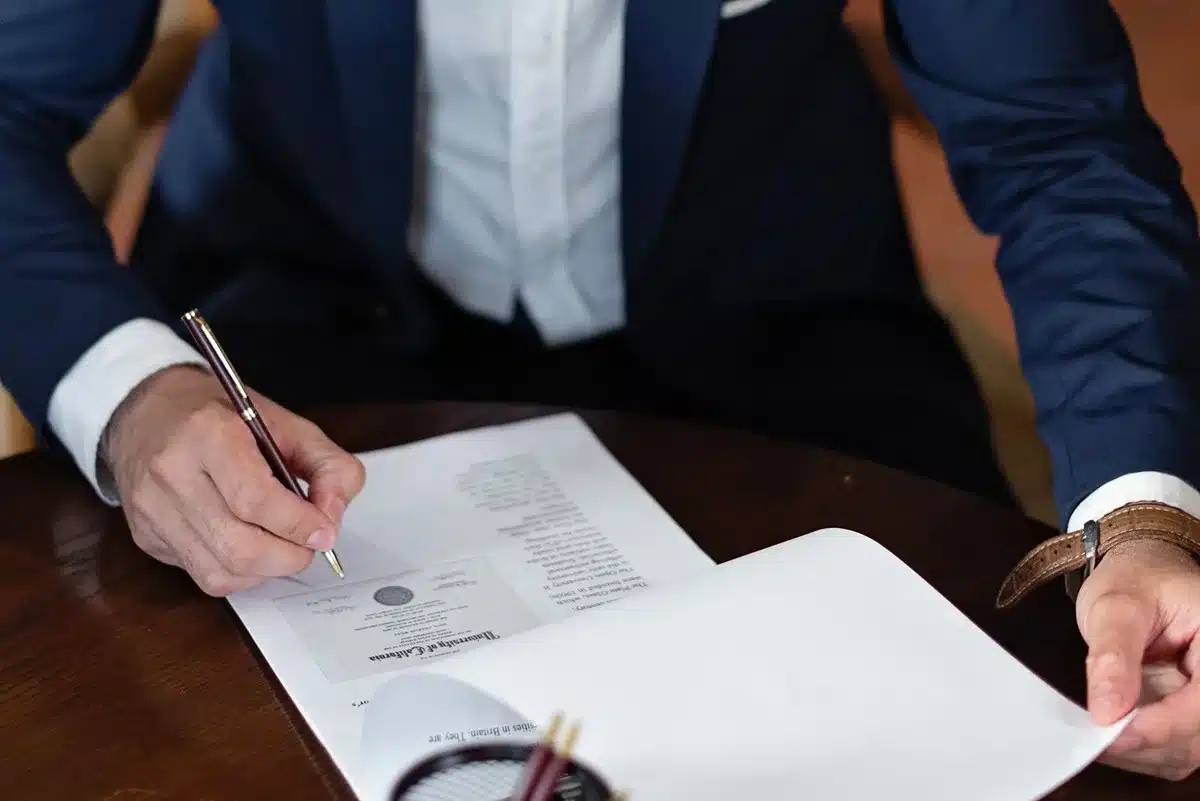 A dimly lit office with a desk and legal documents scattered, a gavel resting nearby, symbolizing executive clemency and presidential authority in shadow.