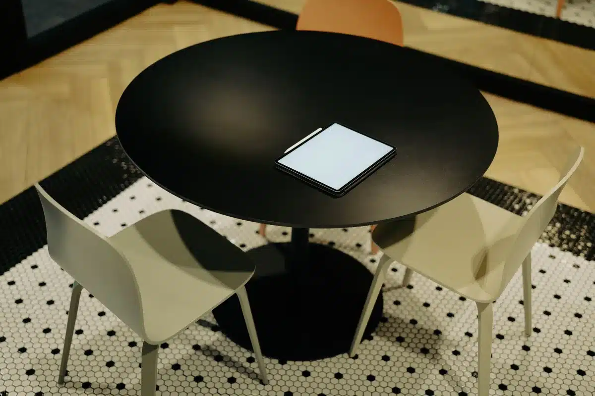 Split-screen showing two empty podcast chairs facing each other, one bathed in warm light and one in cool shadow, symbolizing a bridge between opposing perspectives