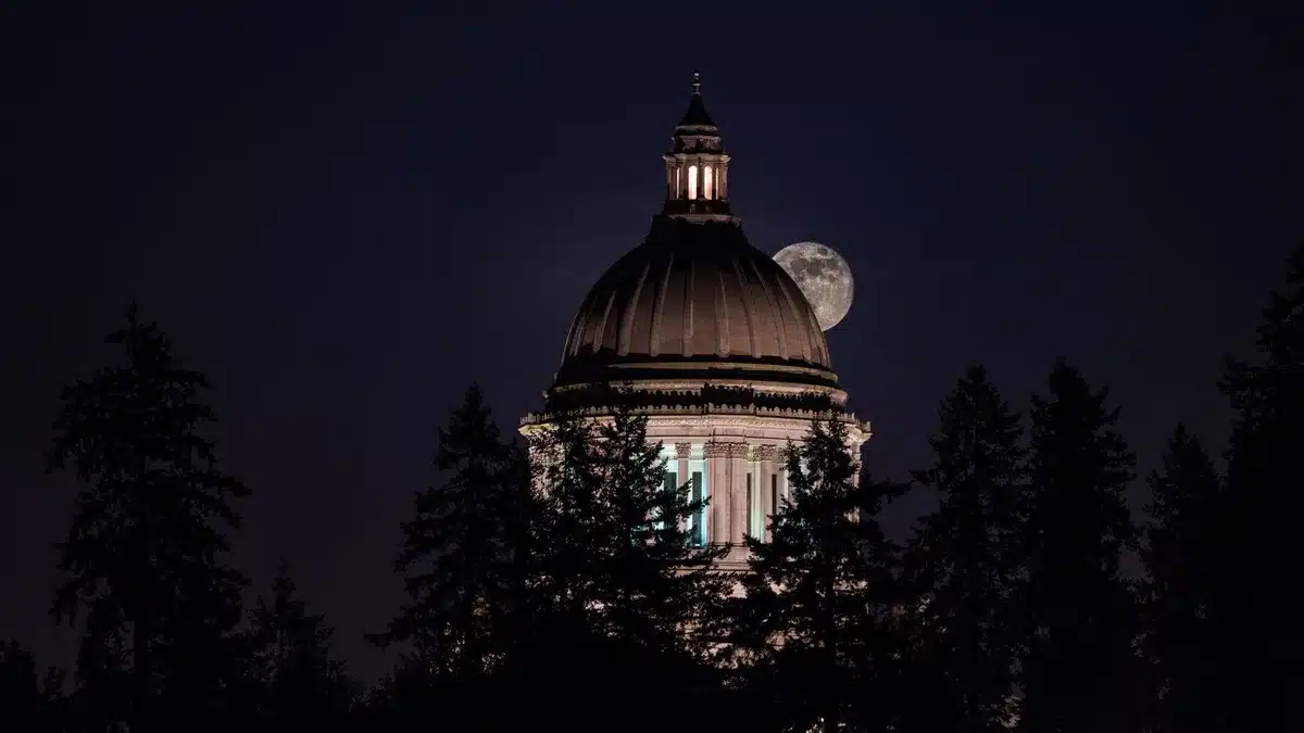 A Minnesota state capitol dome silhouetted against evening sky, reflecting political power and representation in the state