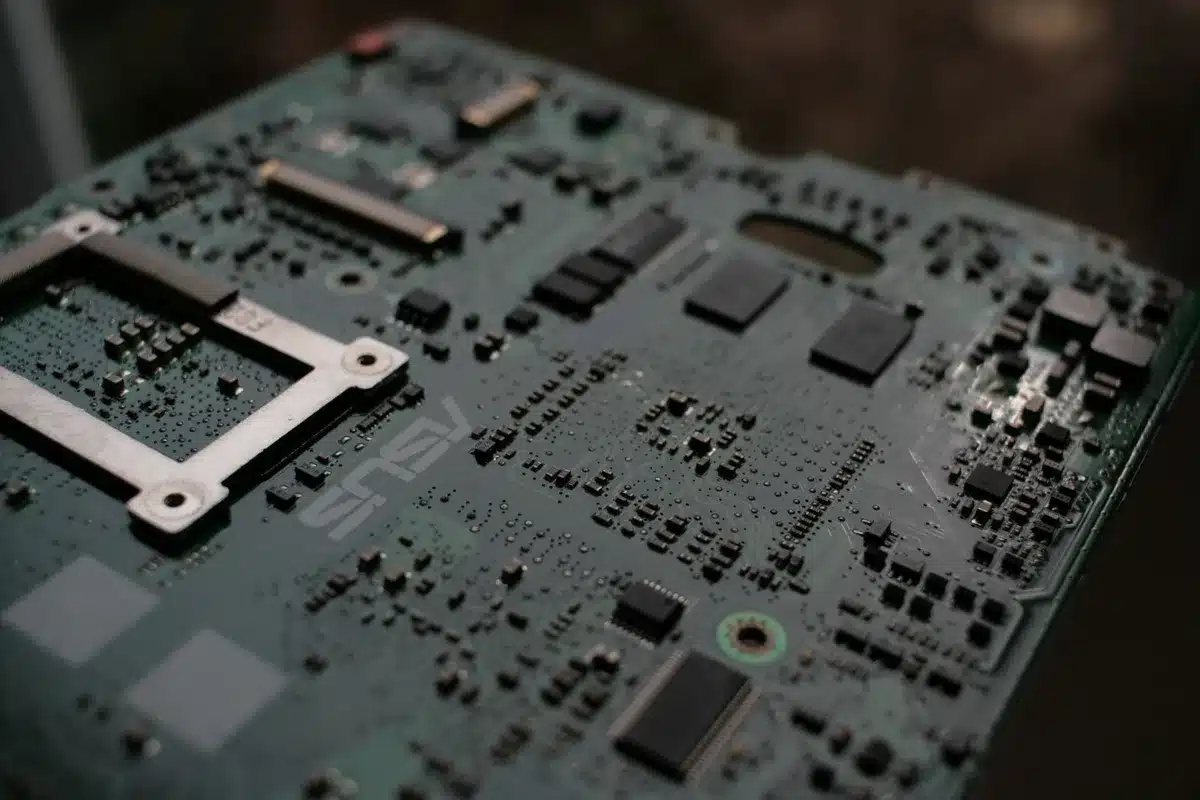 A semiconductor wafer under laboratory lighting, intricate circuit patterns visible, clean room environment blurred in background, precision and innovation evident
