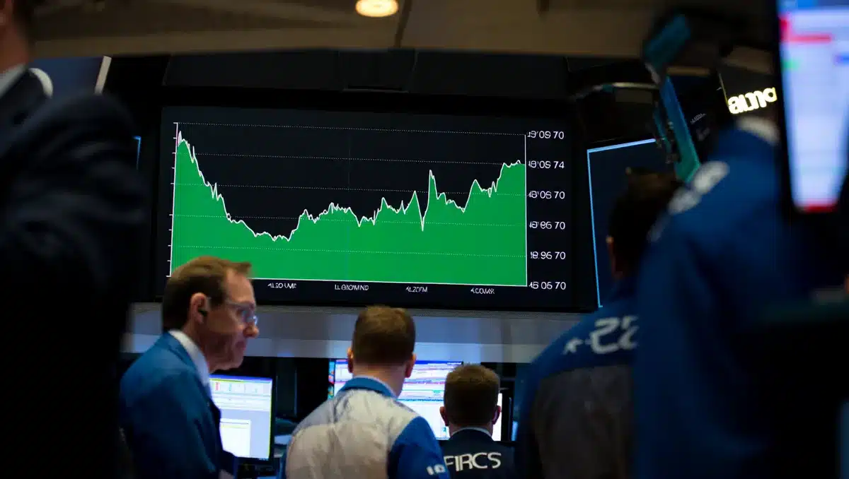 Stock market display showing green upward trend line and financial data, trading screens | stock market gains