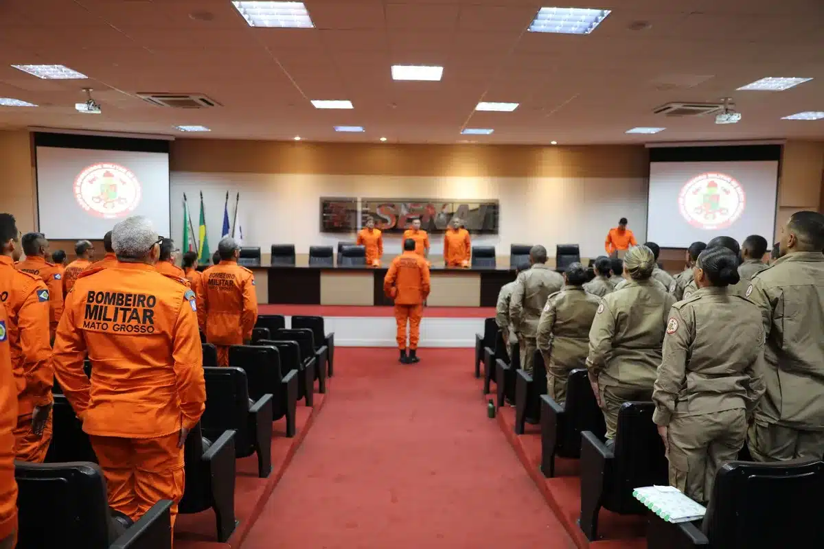Empty military command center with rows of monitors dark, a single red alert light blinking on a control panel, maps of the Middle East pinned to walls, tension and anticipation hanging in the air
