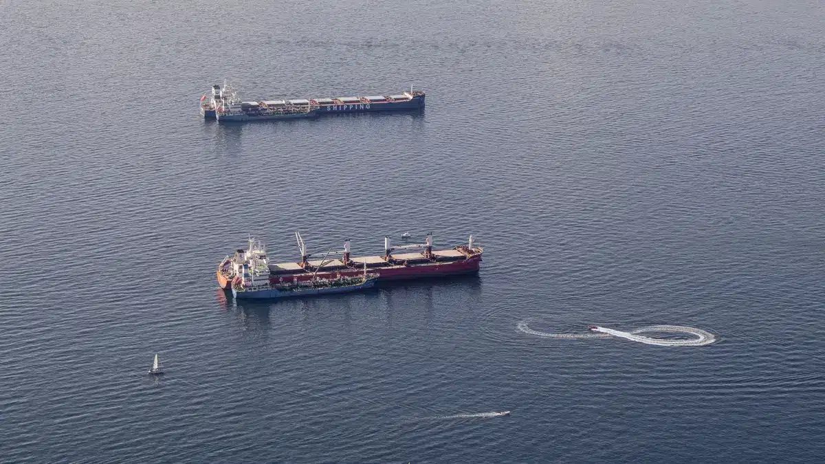 Oil tanker silhouette against twilight sea, smoke rising from deck, emergency lights flashing, crew abandoning ship via lifeboats, chaos and urgency on the water