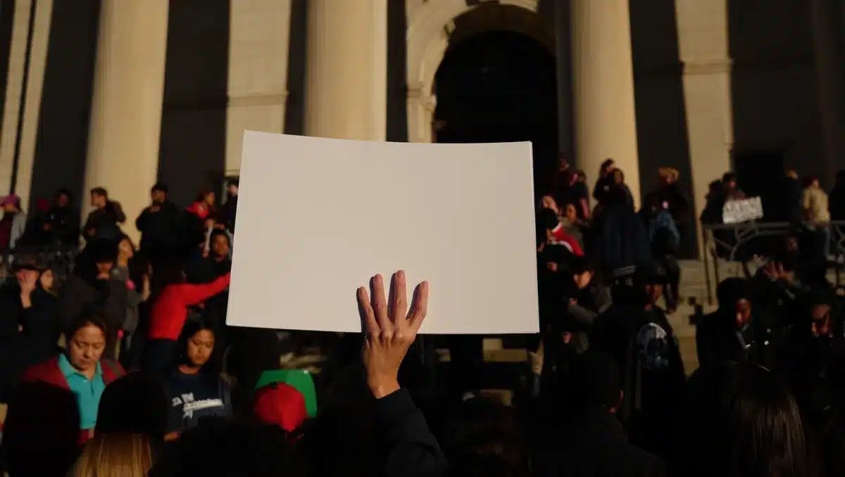 Protest sign or rally scene with voters gathered, diverse crowd silhouettes, courthouse or civic building in background | voters abortion rights amendment