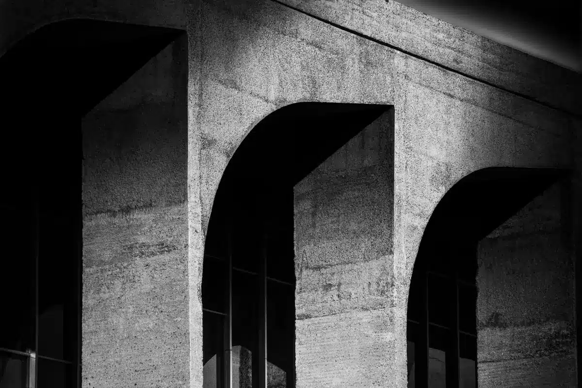 Federal courthouse with American flags, autumn light, empty plaza outside