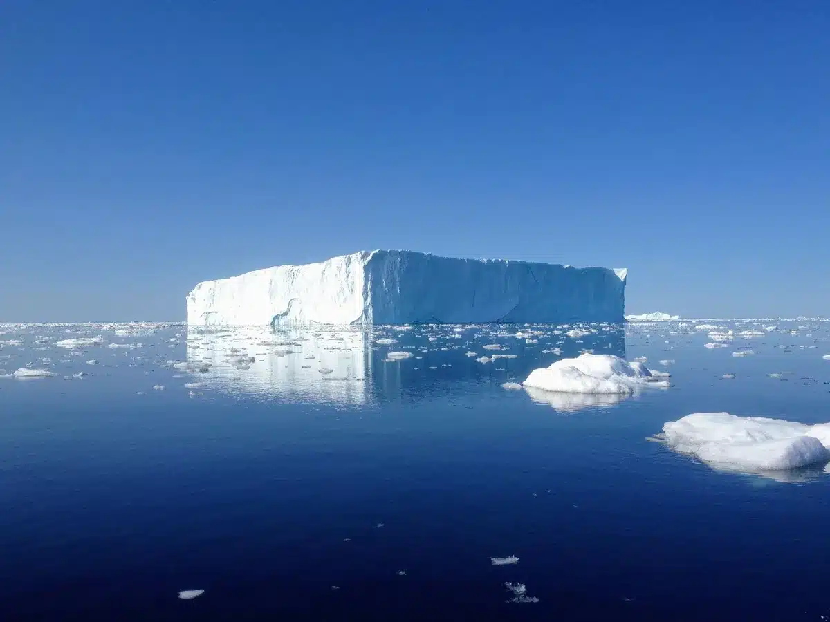 A stark Arctic landscape with glaciers and ice formations, no people visible, evoking geopolitical competition over strategic northern territories