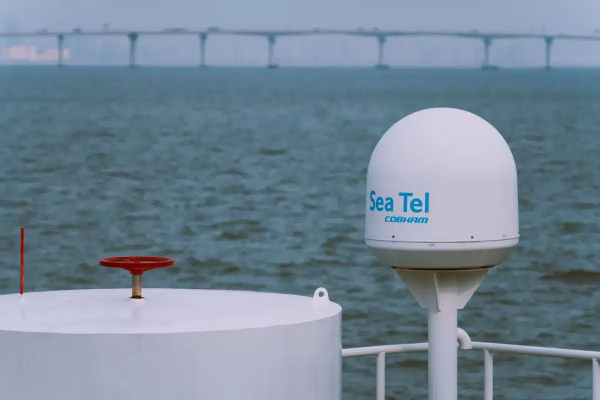 A modern weather radar dome against a blue sky, with antenna array visible inside, representing advanced meteorological technology