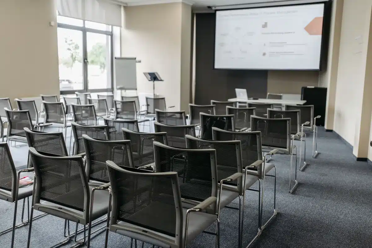 Empty Army headquarters conference table with nameplate and chair, soft lighting, no people visible