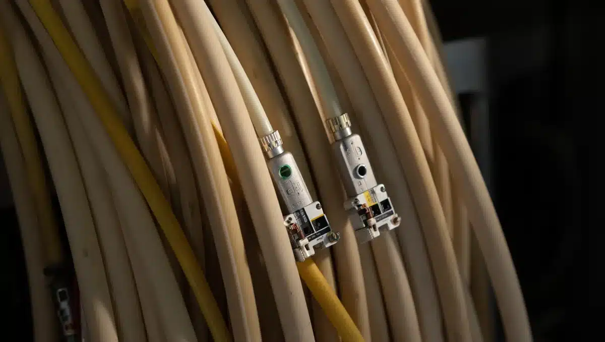 A close-up of optical transceiver components or fiber optic cables under laboratory lighting, showing the technical components at the heart of AI data center infrastructure | optical fiber transceiver components