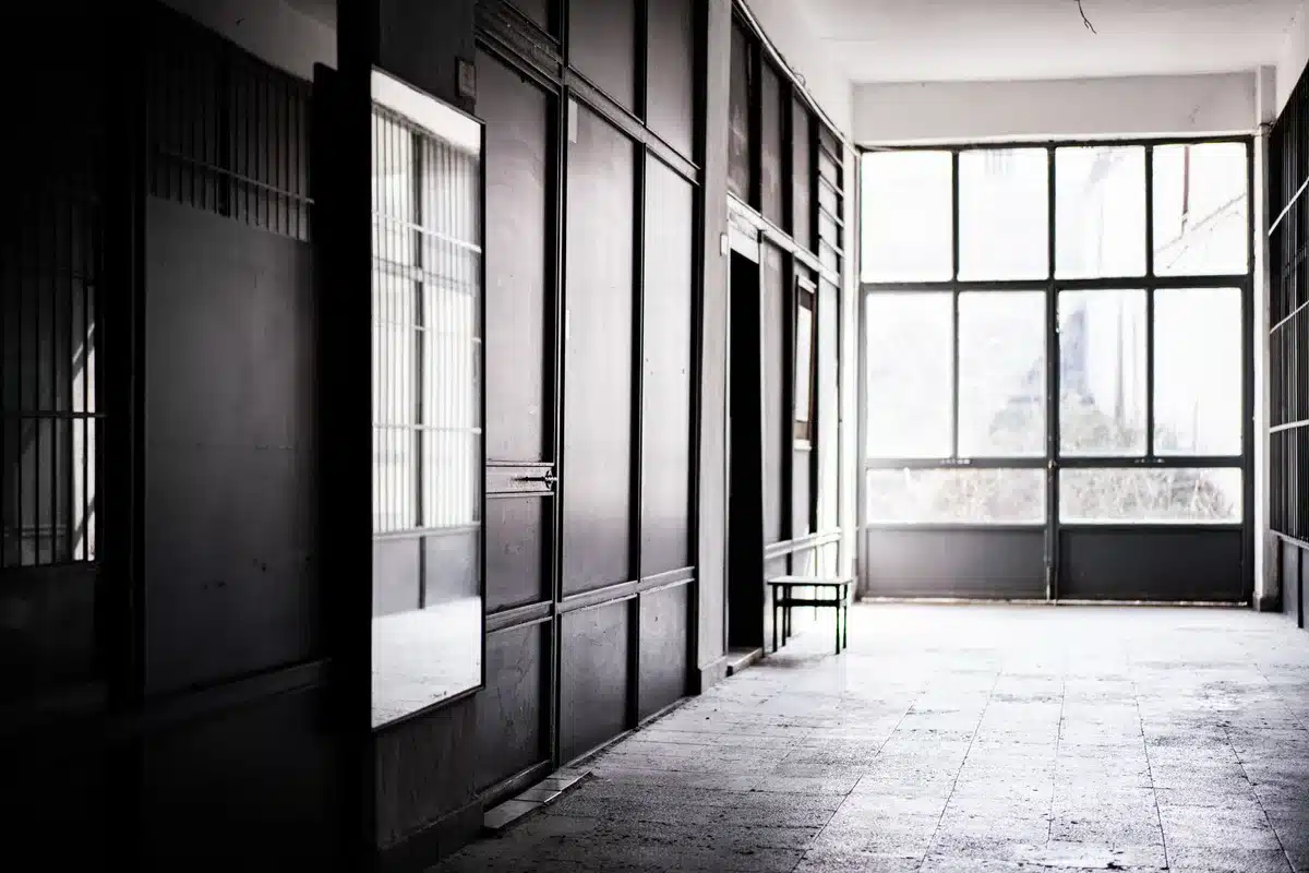 The halls of Congress in soft light, an empty office with a desk and nameplate, a closing door symbolizing the end of a political era
