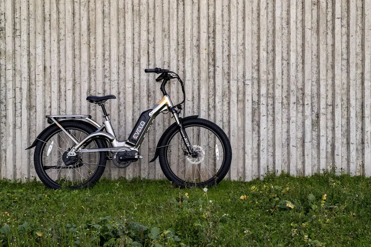 A smartphone screen showing an online marketplace listing for a high-speed e-bike, with bright product images and "Add to Cart" button visible, the device specifications blurred in soft focus