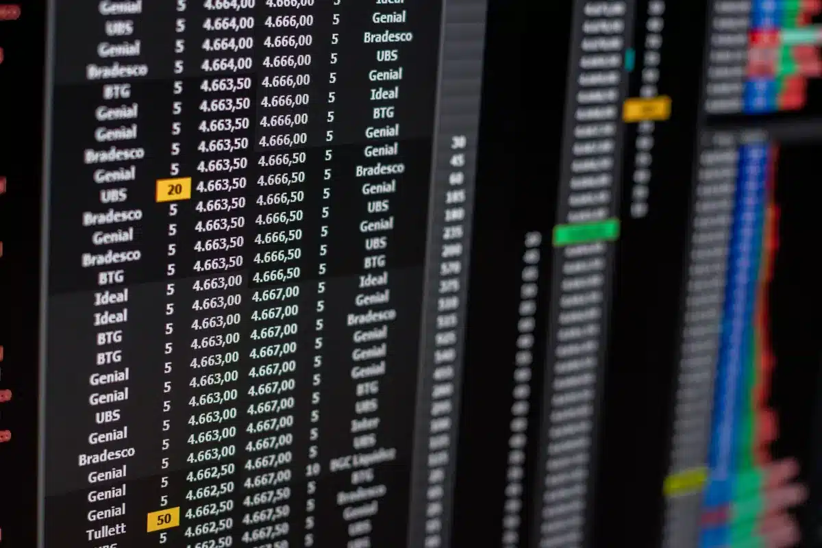 A glowing stock market ticker displaying semiconductor company symbols and rising green candles, reflecting upward momentum and investor optimism in tech stocks.