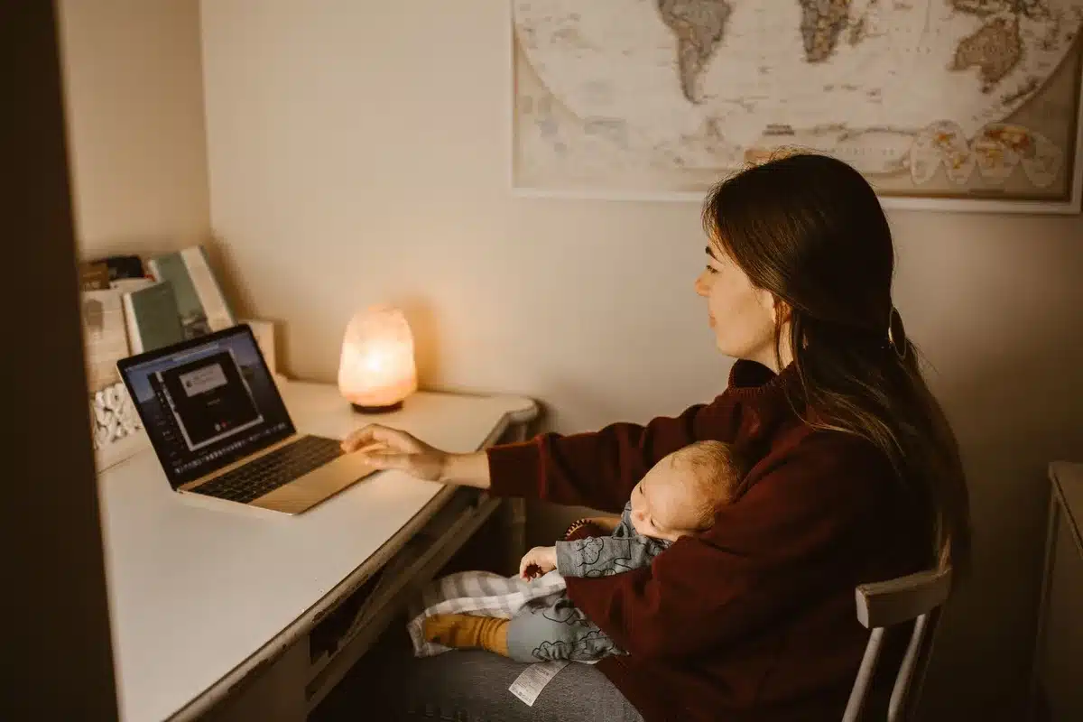 A professional woman in formal attire at a podium, silhouetted against a blurred White House backdrop, with a small family photo subtly visible on the desk beside her, capturing the tension between high office and parenthood.