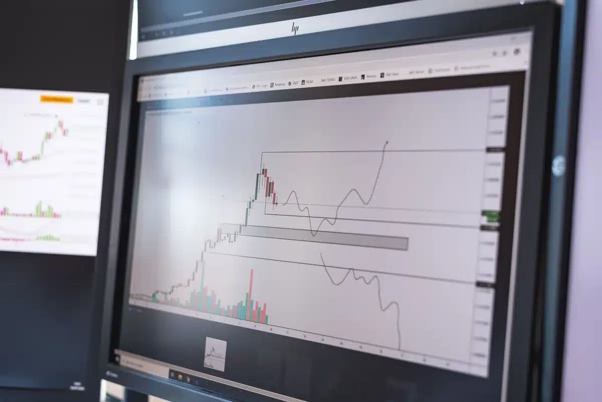 A crowded trading floor with multiple screens displaying red market data and downward arrows, traders in tension, financial data streams flowing, urgent energy in the room